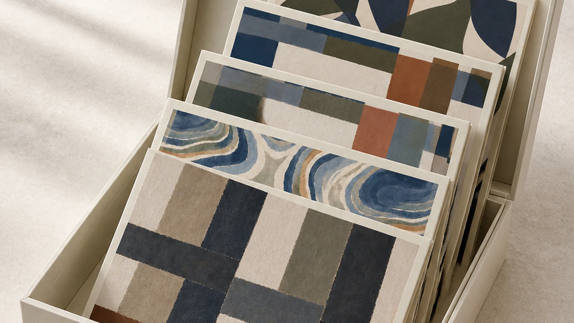 An open sample library box showing folded fabric swatches.